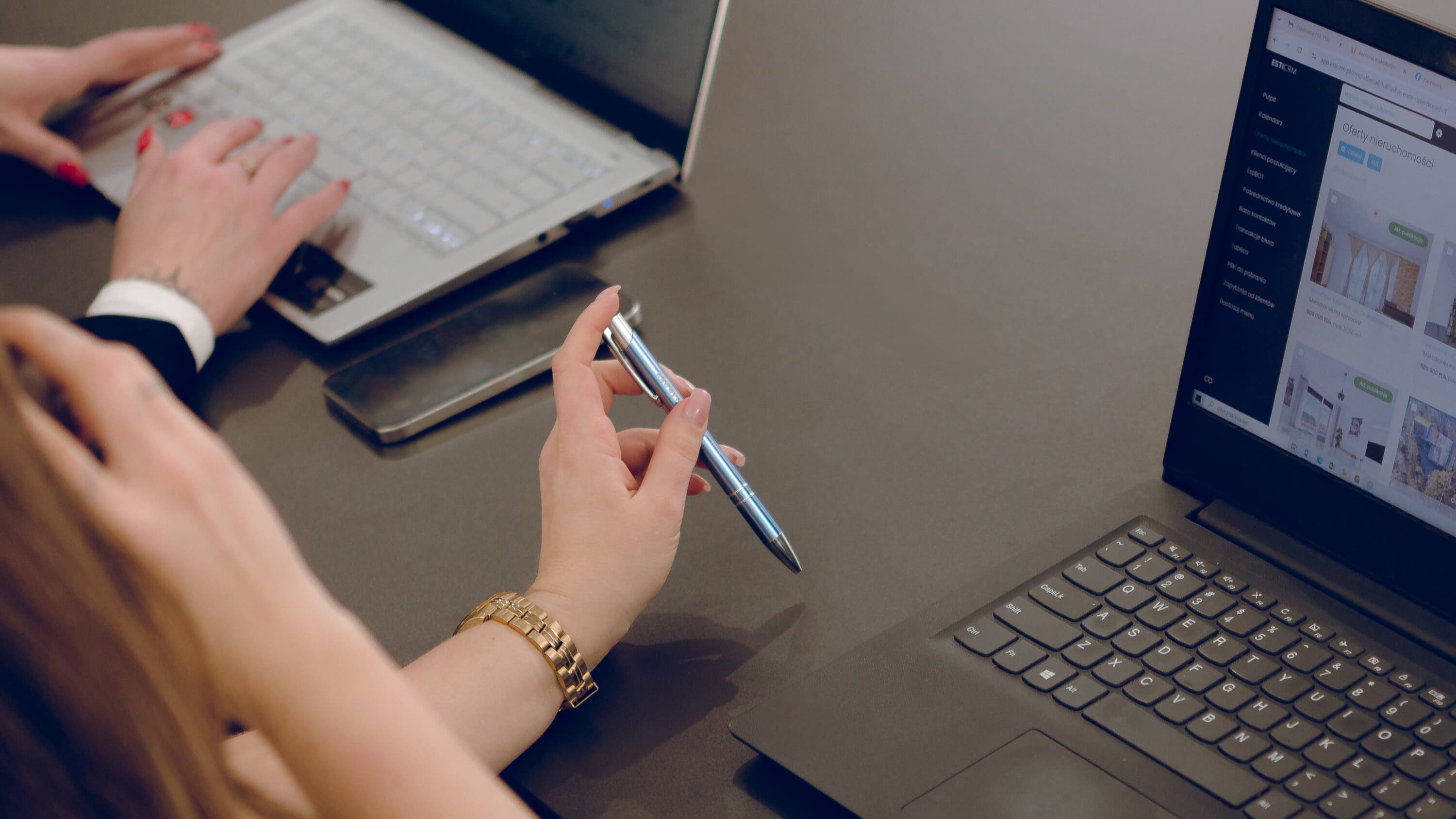 Female colleagues discussing the content on a laptop screen while working.