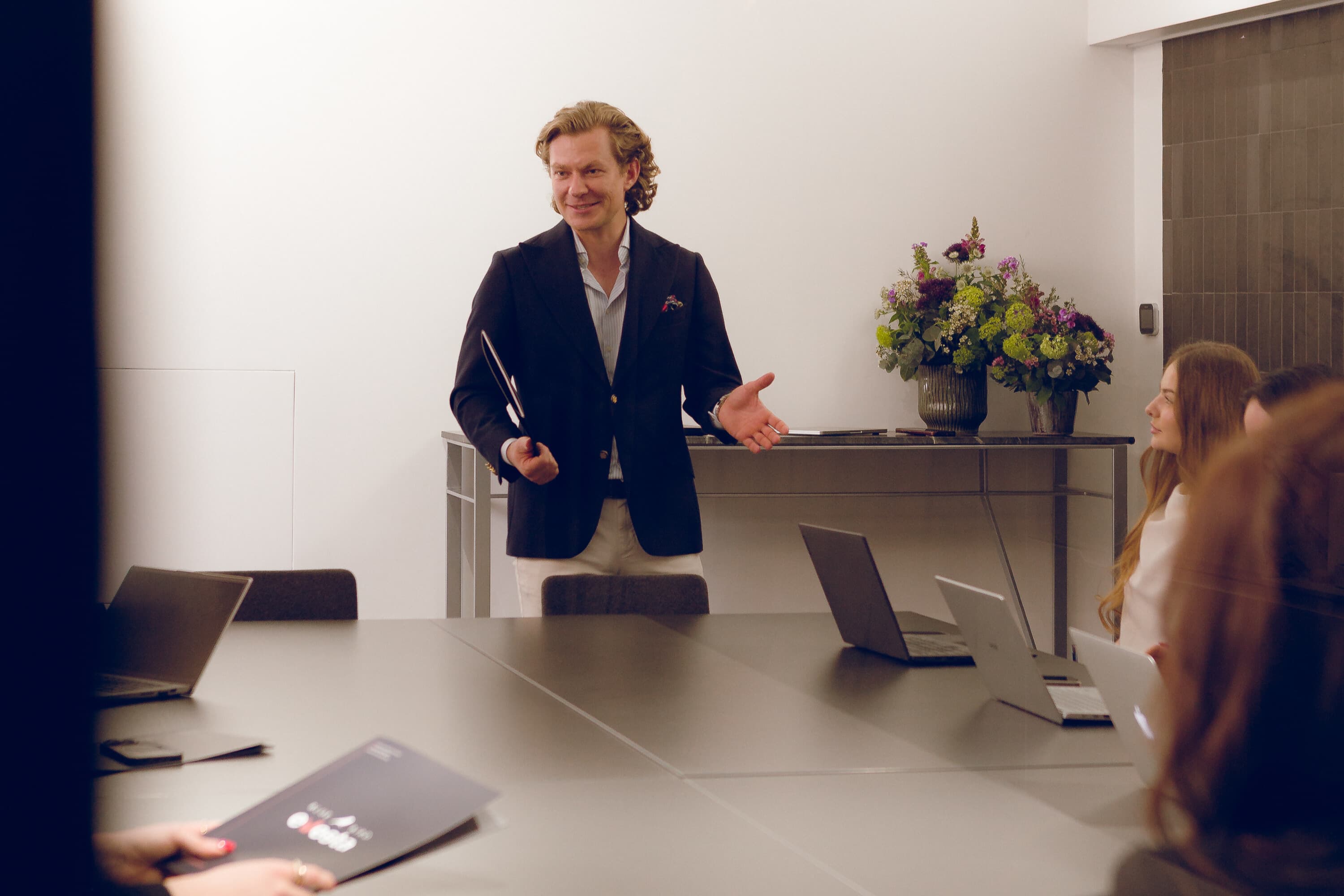 A man gives a presentation to a team in a conference room. Sources and related content